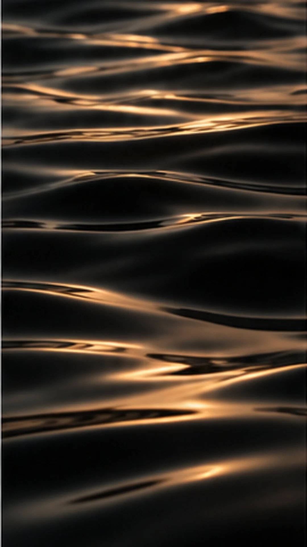 Rippling dark water with warm reflected light